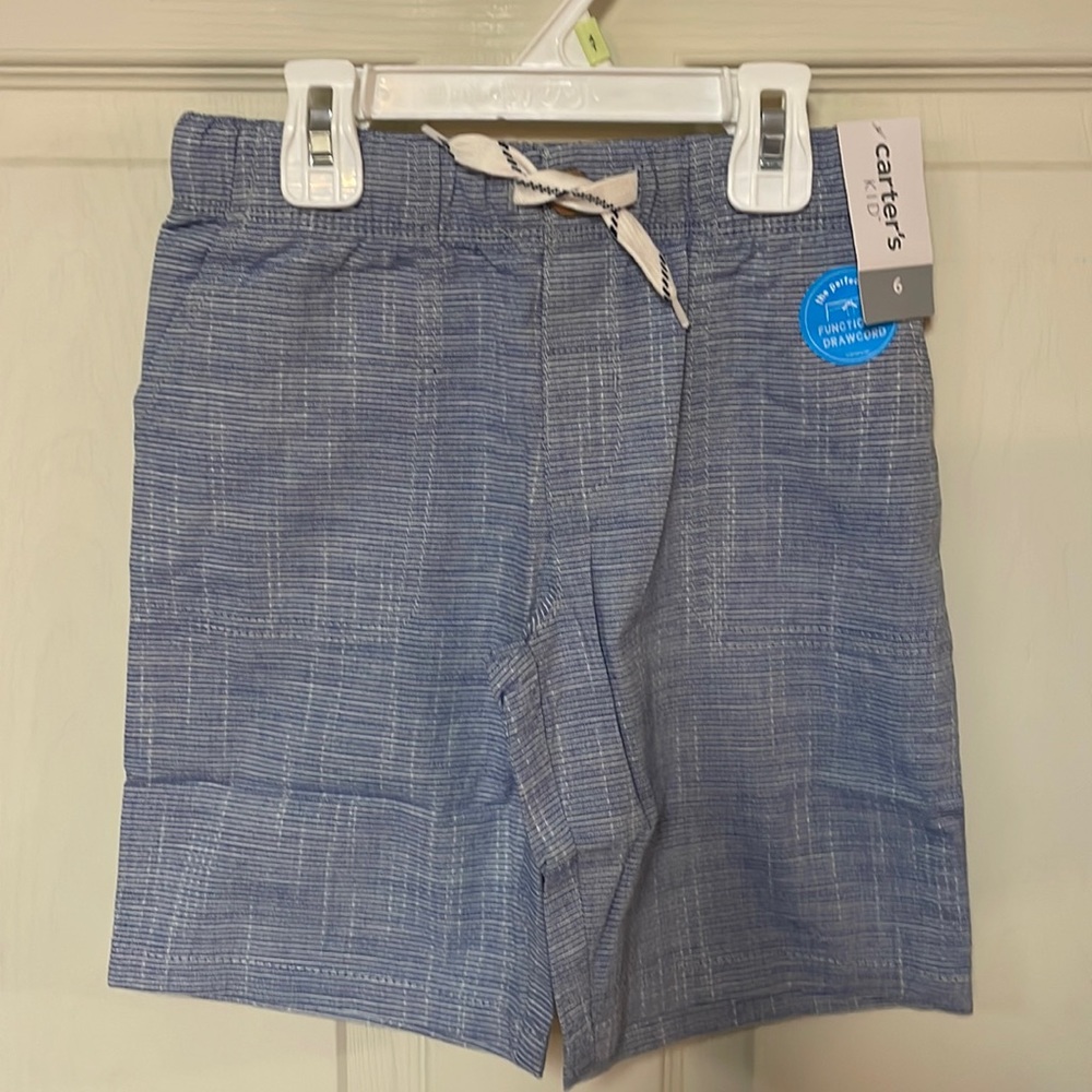 White short sleeve Old Navy shirt and chambray striped Carter’s shorts.